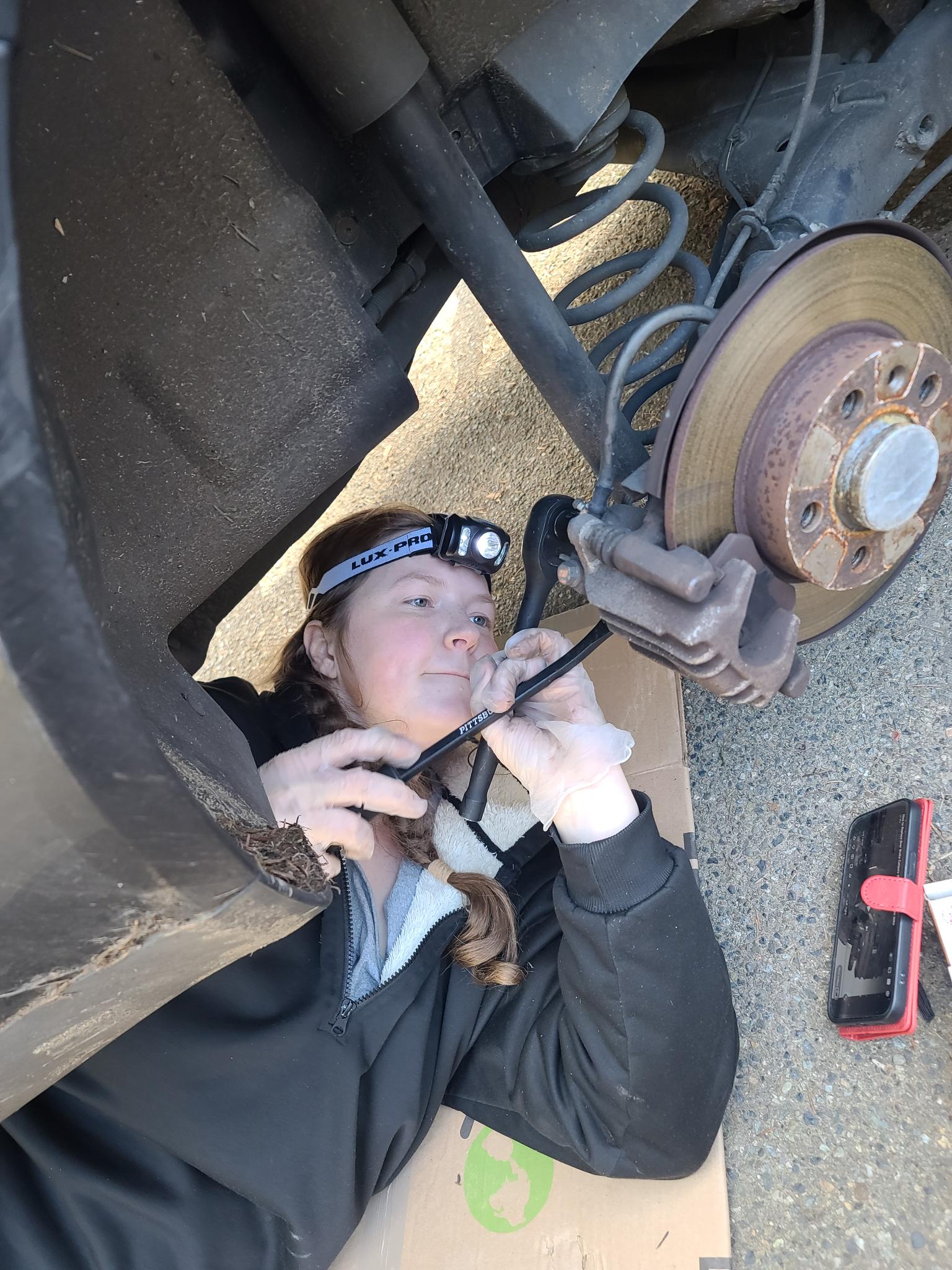 Melissa Chaudhry repairing a car